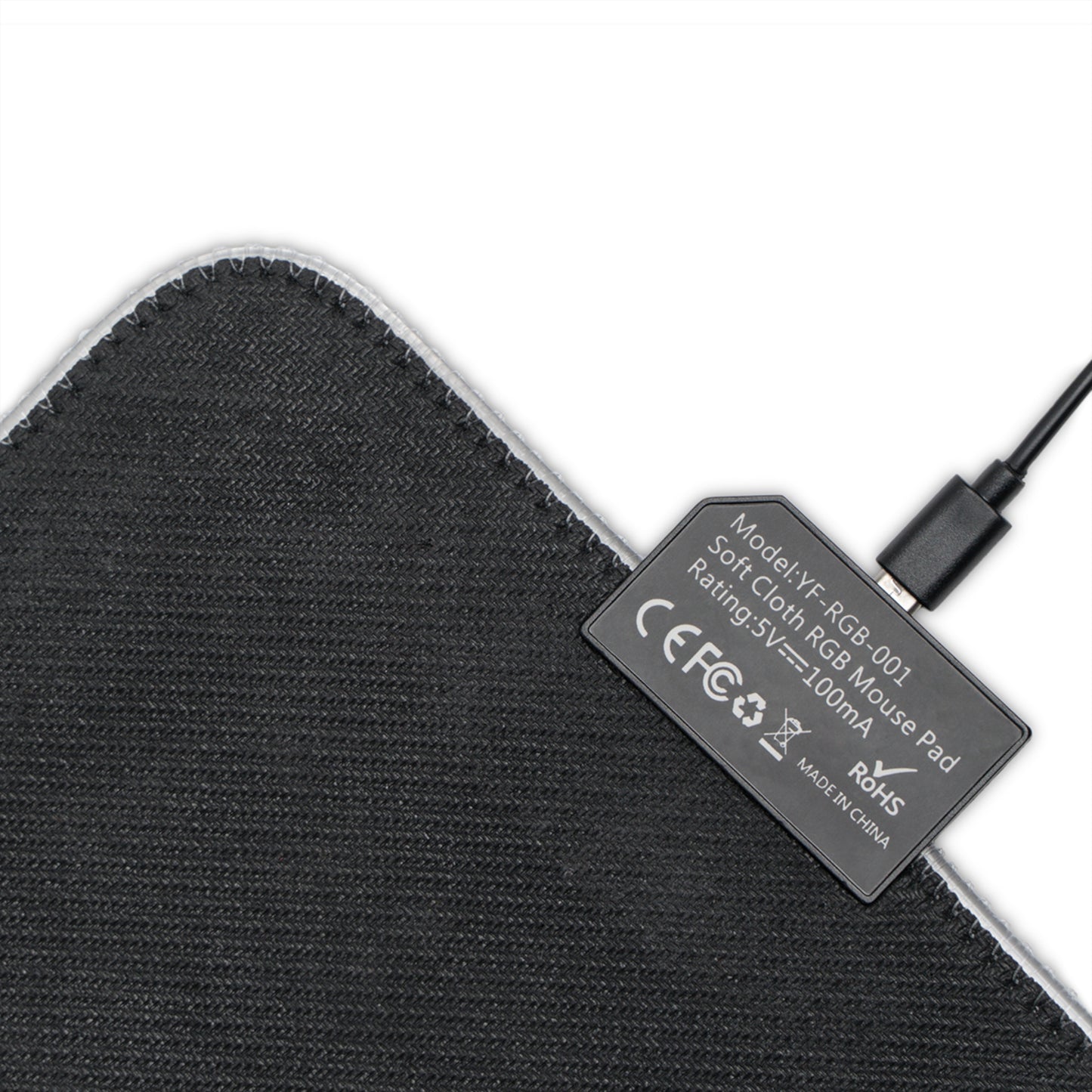 Black fabric mouse pad underside with regulatory label and attached cable
