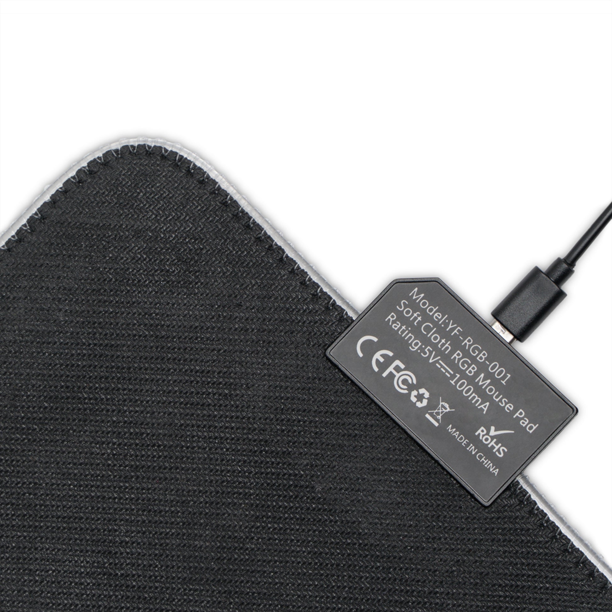 Black fabric mouse pad underside with regulatory label and attached cable