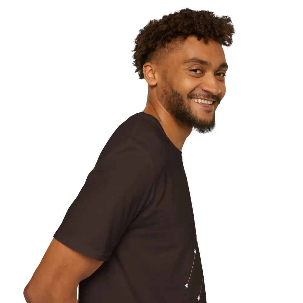 Smiling man wearing black unisex softstyle constellation astrology T-shirt with low heat care