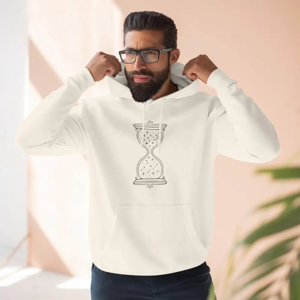 Man wearing a cream-colored fleece hoodie with an hourglass graphic, perfect for all seasons