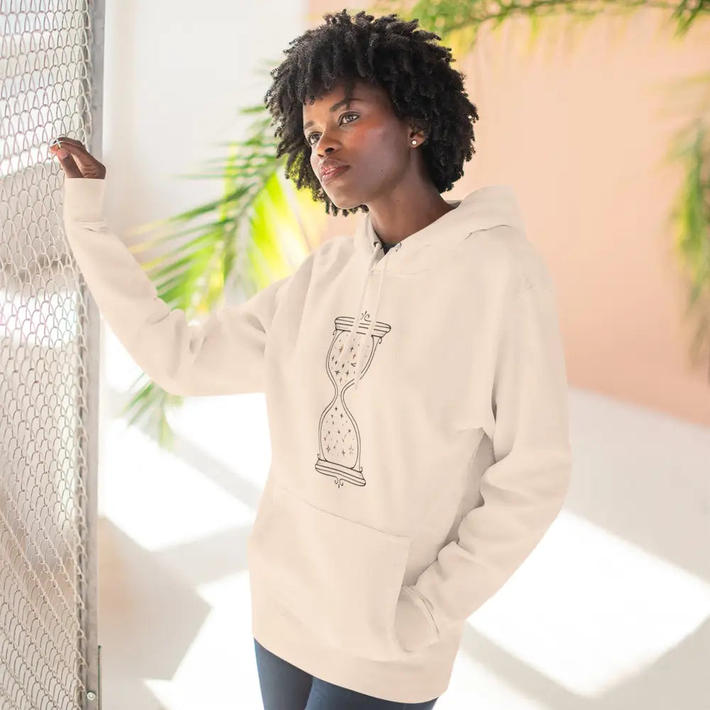 Off-white fleece hoodie with black hourglass design, perfect for all seasons and low heat care
