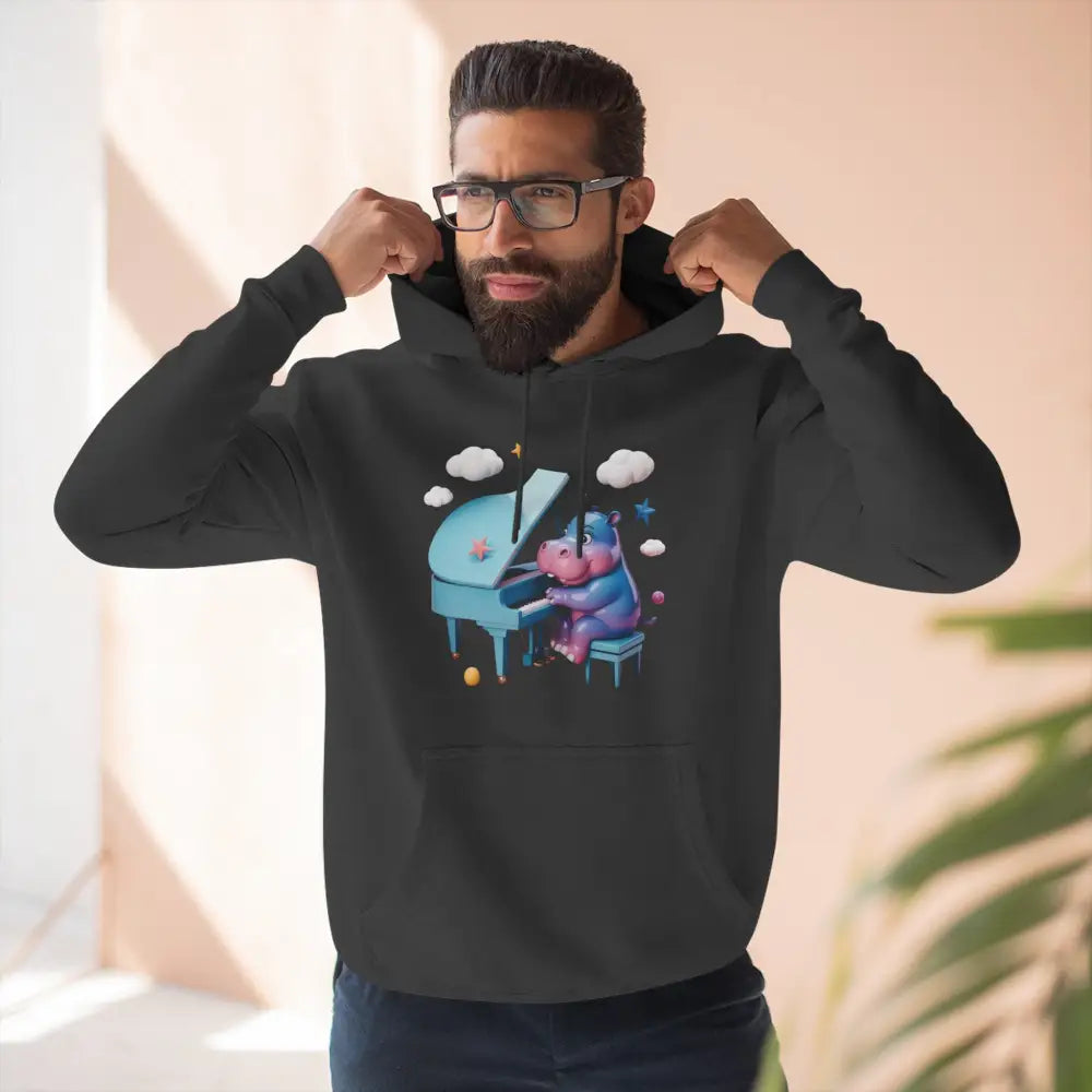 Black fleece hoodie with a playful cartoon hippopotamus playing piano, perfect for music lovers