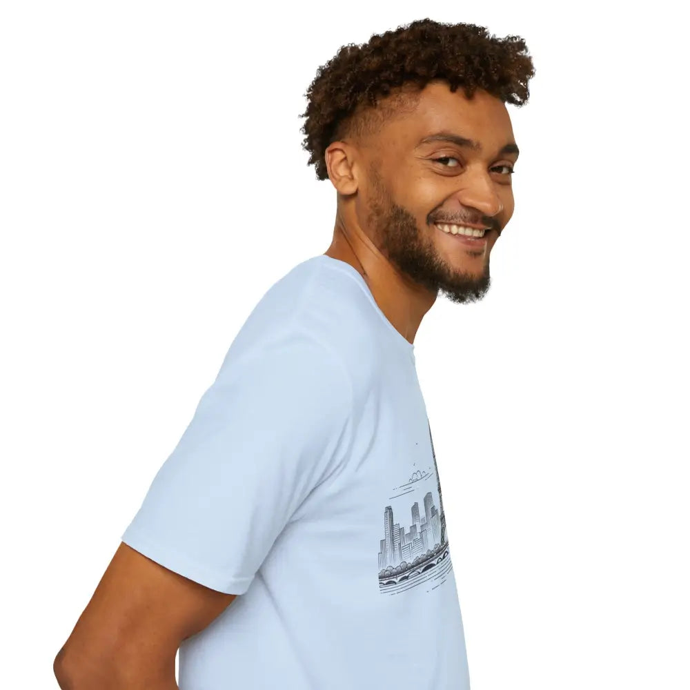 Man with curly brown hair and beard wearing Paris Skyline Graphic T-Shirt with ribbed collar retains