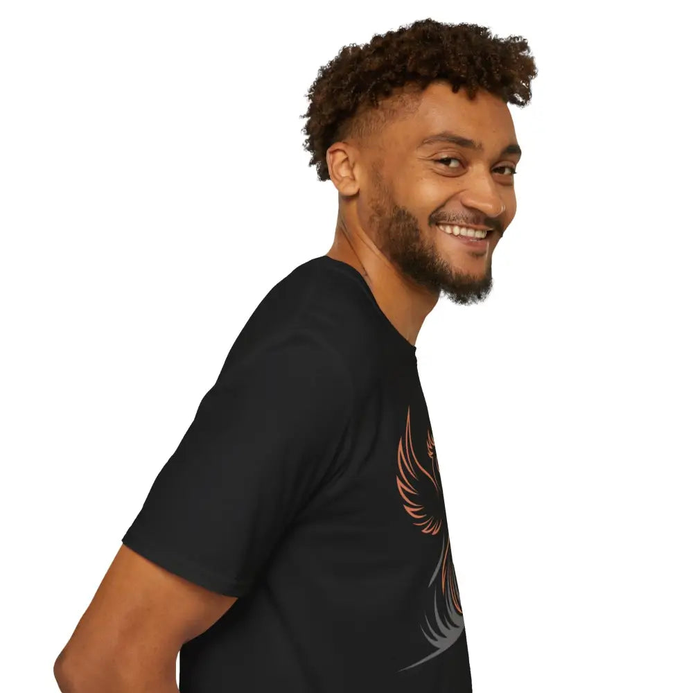 Smiling man in black Phoenix Rising T-Shirt with winged design, elastic ribbed knit