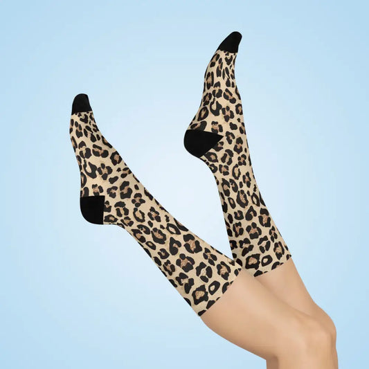 Two feet in wild leopard print cushioned crew socks with black toes and heels